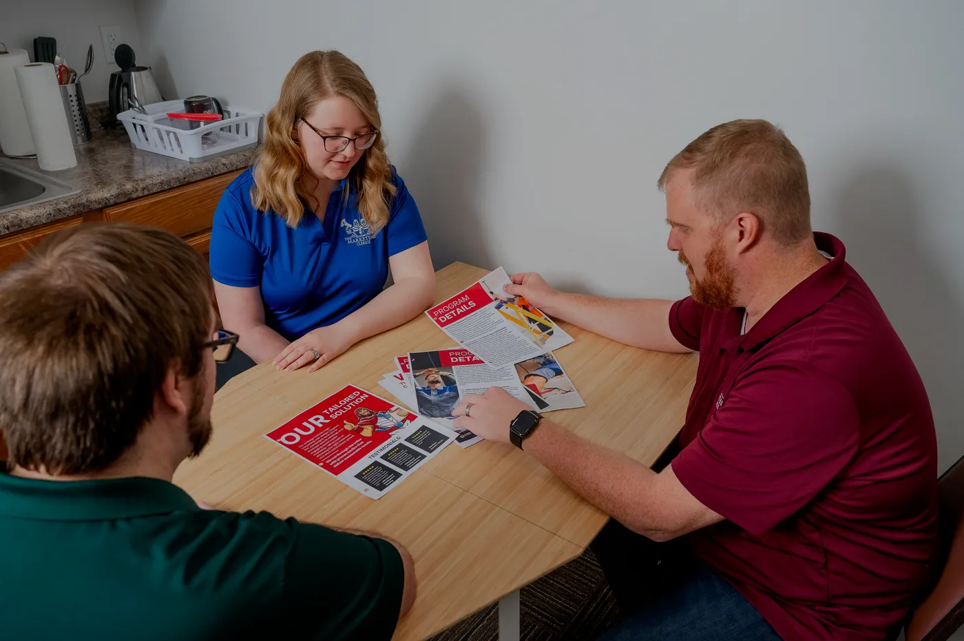 The Marketing Clerics team reviewing a client's program together